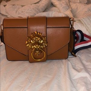 Beige cross body gold lion bag